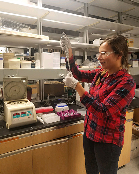 robuck conducts chemical analysis in a lab