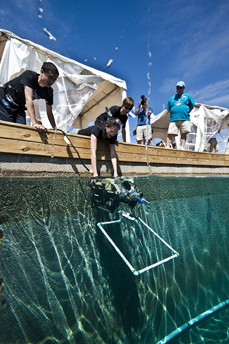 students launch a submersible into a water tank