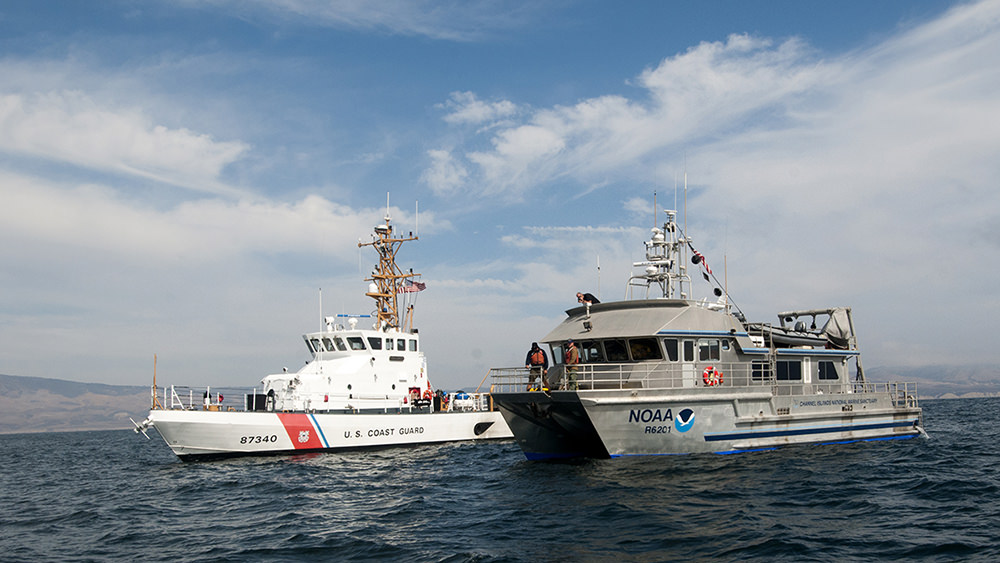 a us coast guard ship and a noaa ship at sea