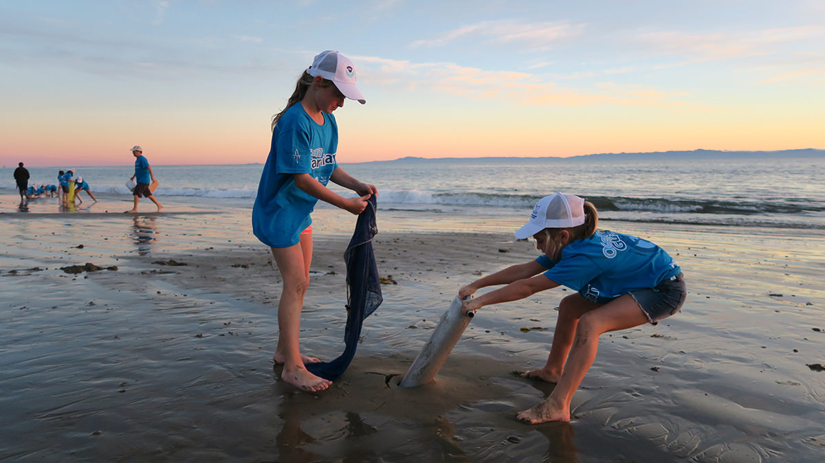 two young students monitor sand crabs