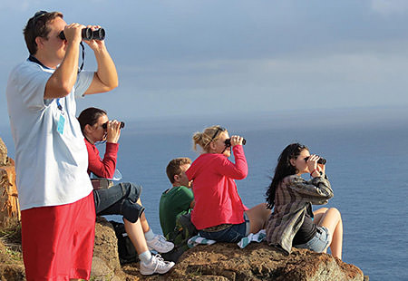 people looking through binoculars