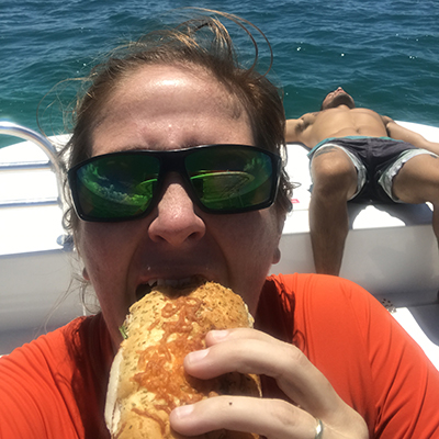 selfie of a person eating a sandwich