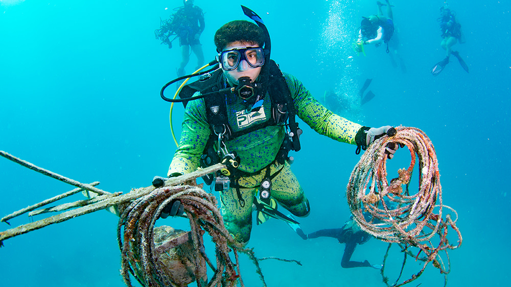 diver holding marine debris