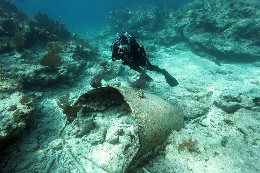diver documenting a shipwreck structure