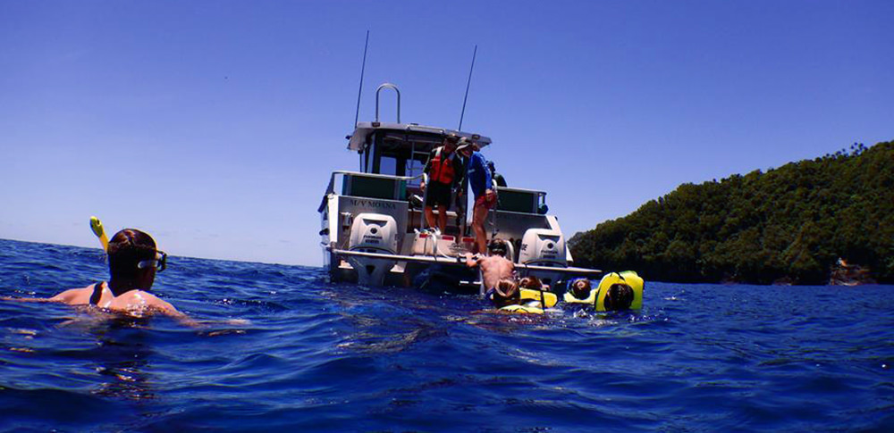 snorkelers near a boat