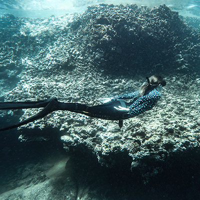 a freediver over coral