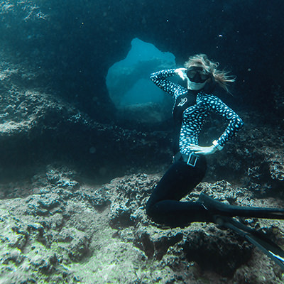 freediver posing in front of corals