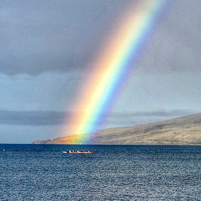 rainbow over outrigger canoers