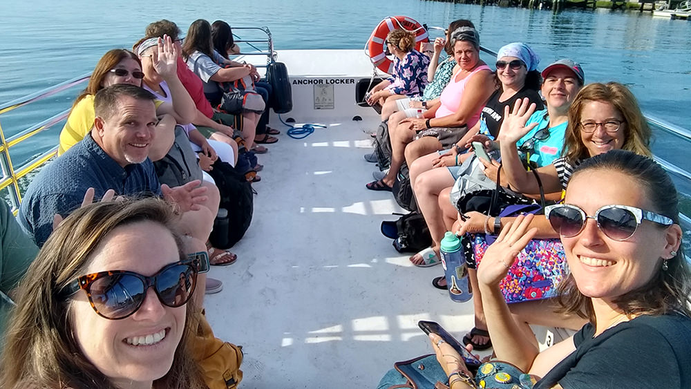 teachers gathered together on a small boat