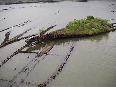 An aerial photo of a shipwreck in mallows bay potomic river national marine sanctuary