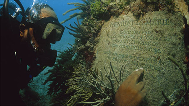 a diver at the henrietta marie memorial plaque