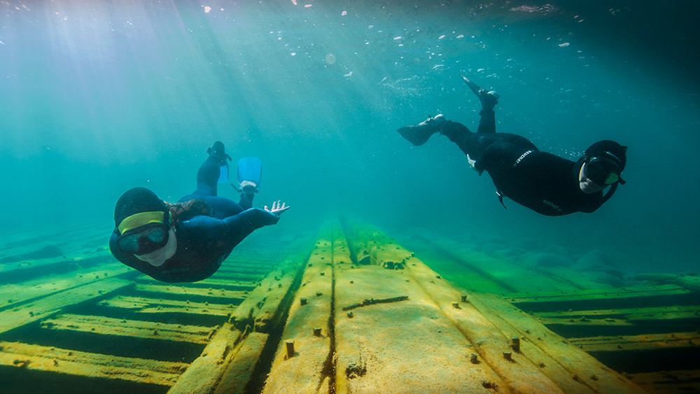 two snorkelers over a shipwreck