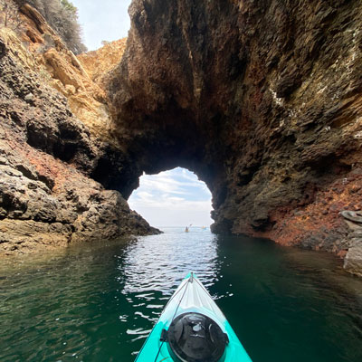 View from a kayak under an arch
