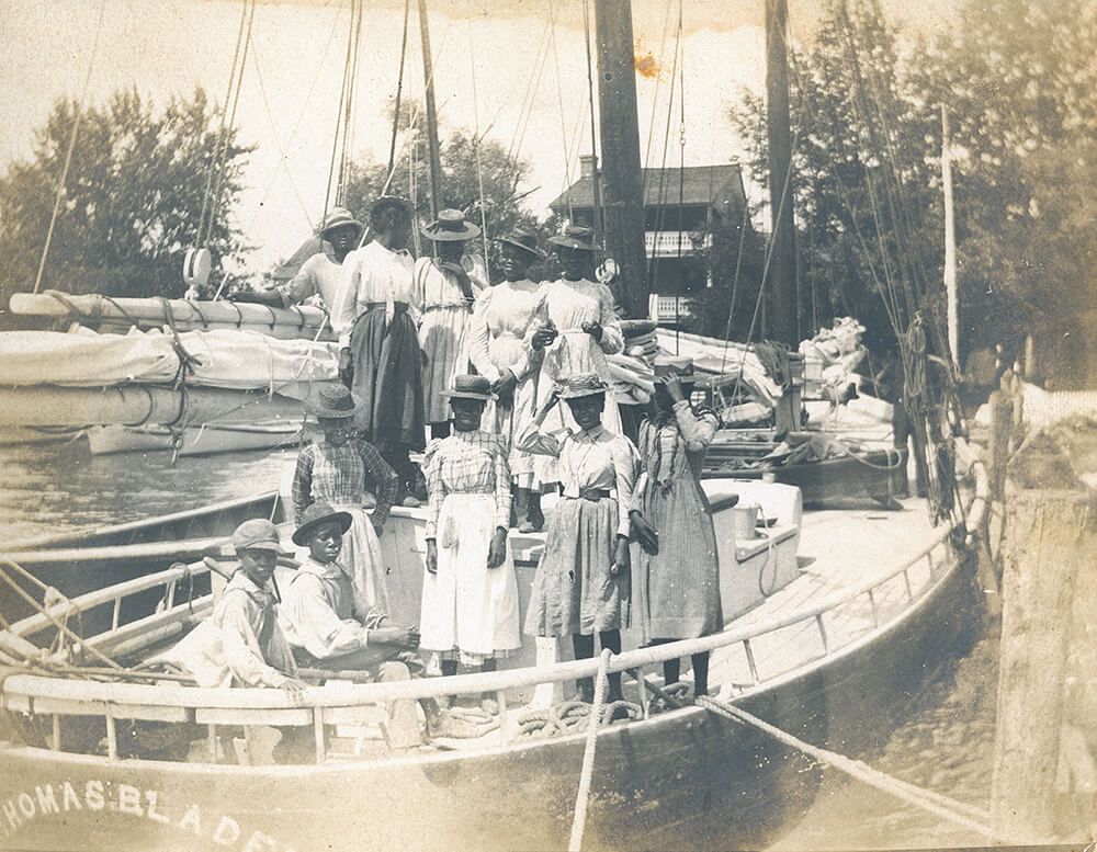black and white photo of people on a boat