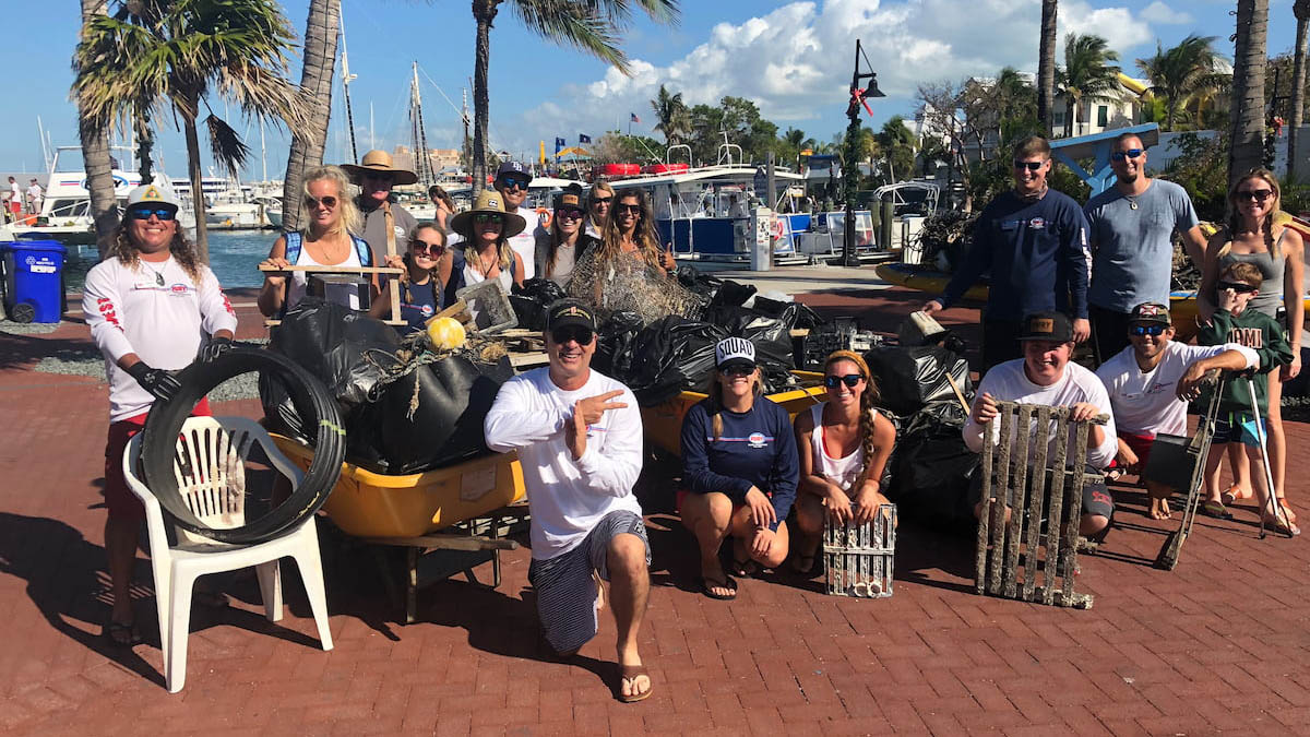 group of people with collected marine debris