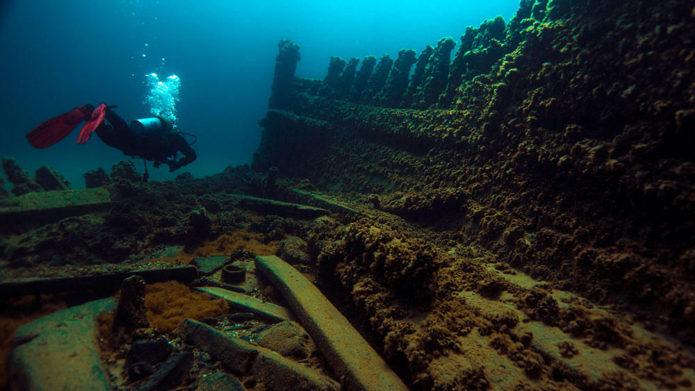 A diver explores the Lucinda Van Valkenburg shipwreck