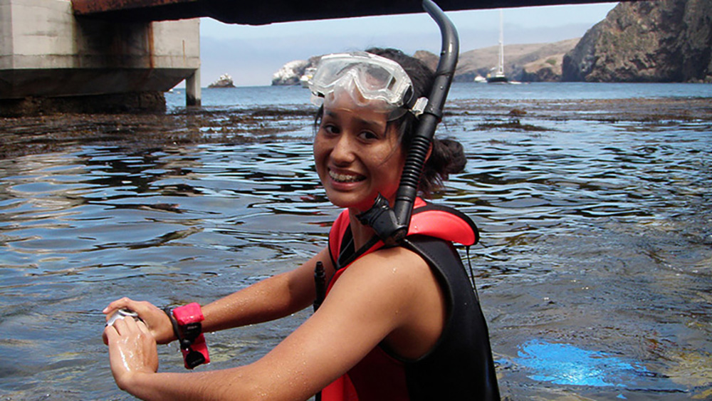 Brijonnay standing in shallow water with her mask and snorkel on
