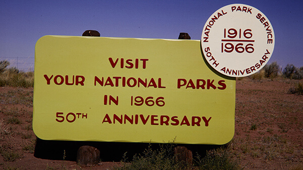 a yellow sign that says visit your national parks in 1966, 50th anniversary