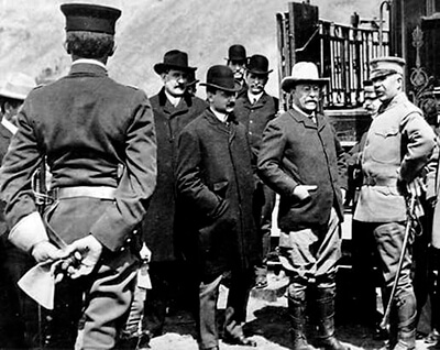 black and white photo of President Roosevelt standing with a group of people