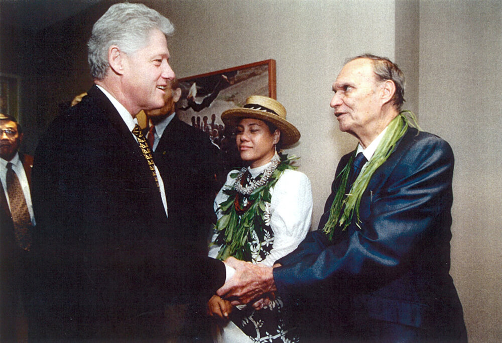 President Clinton shaking hands with another man