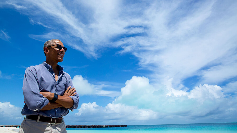 President Obama stands on a beach