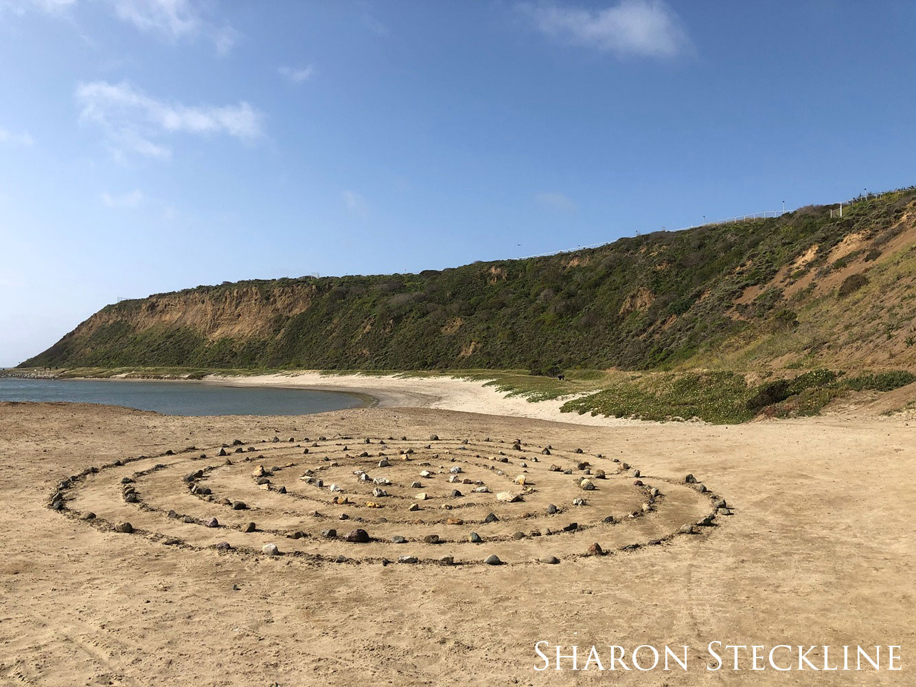 Circles of rocks on a beach.