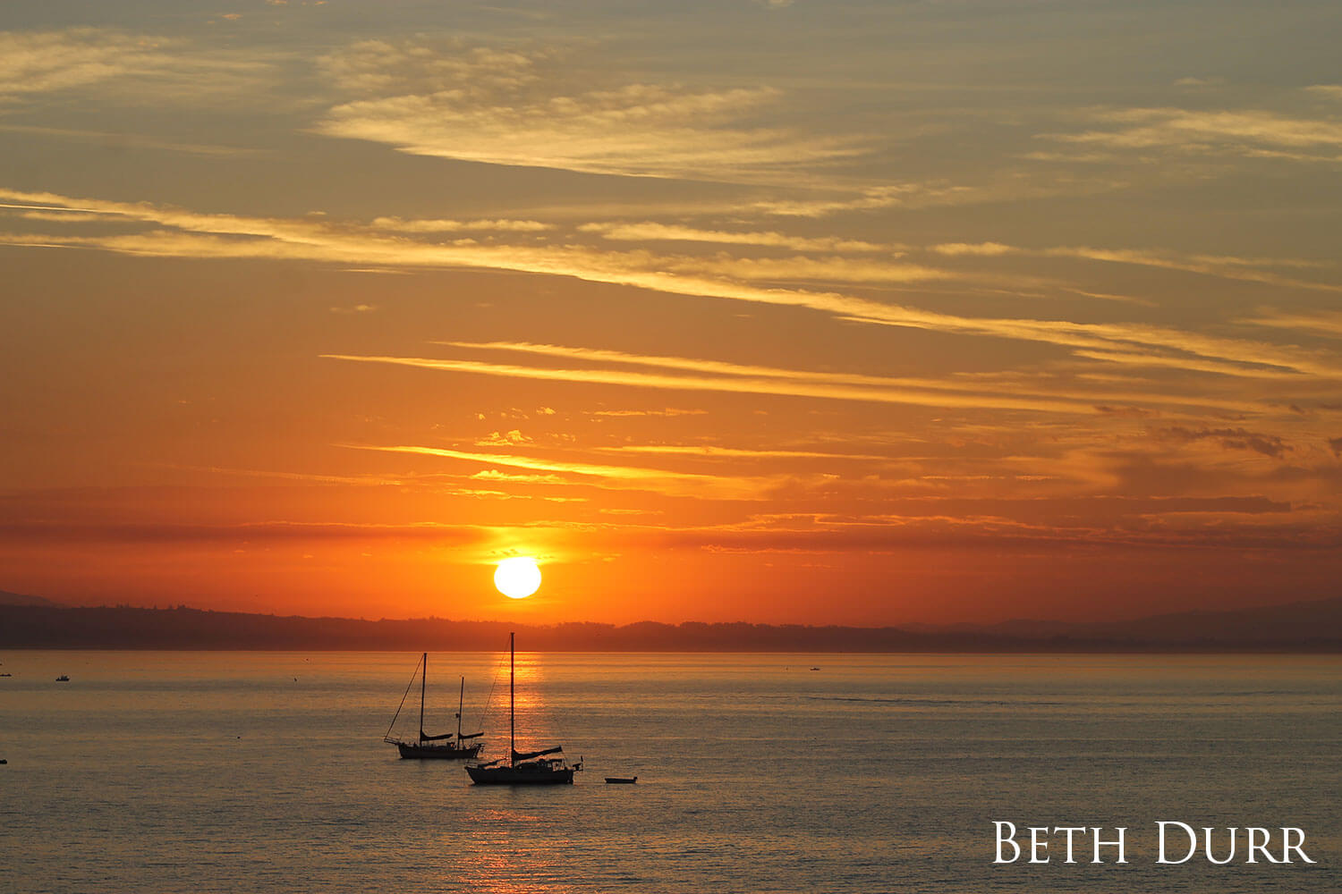 Two sailboats at sunrise. 