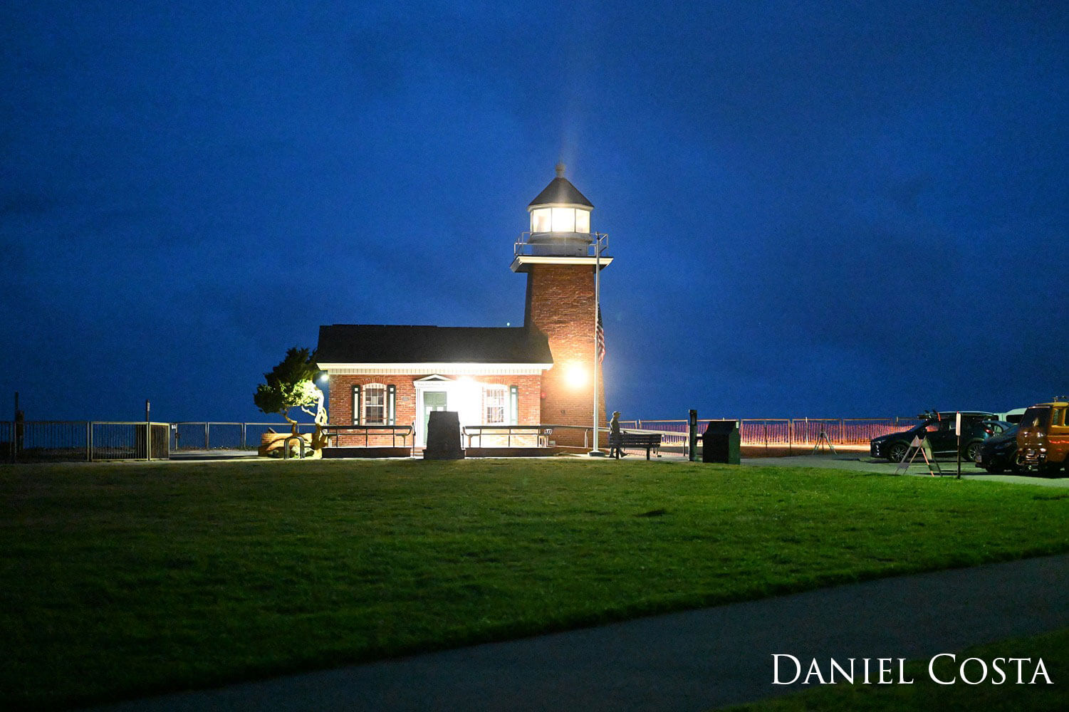 Illuminated lighthouse during the night.