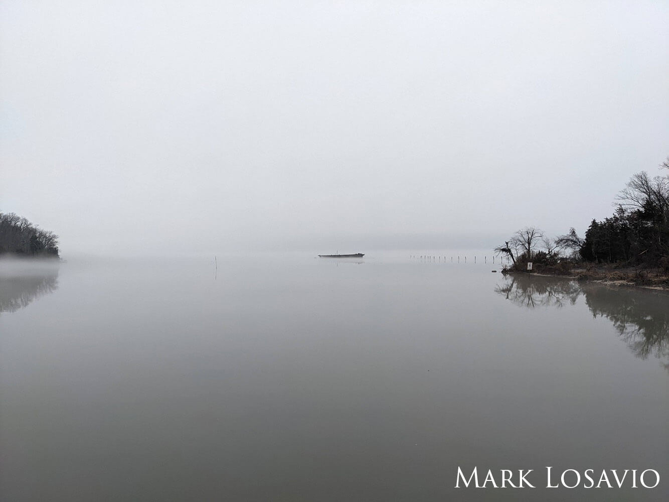 A lone wreck in the fog.