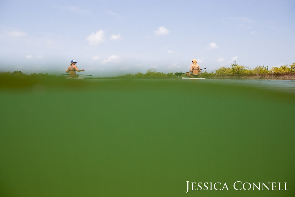 Two people sit on paddle board in the Florida Keys.