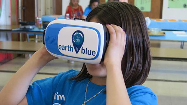 a child looks through vr goggles