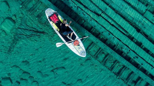 Single person kayaking in clear water