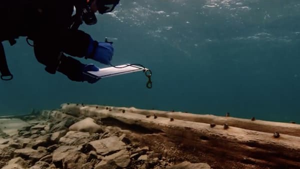 Diver taking notes at a shipwreck
