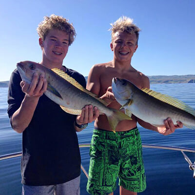 two boys show off fish