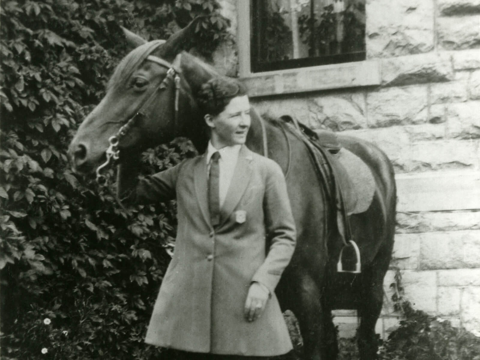 A woman stands with a horse