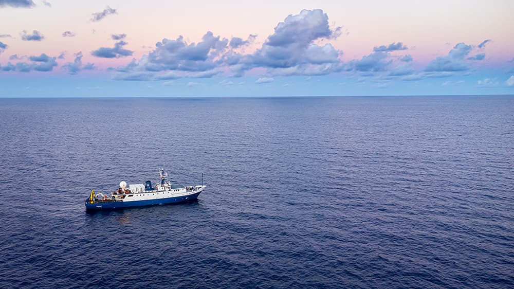 aerial view of ev nautilus at sea surrounded by vast ocean with horizon and clouds