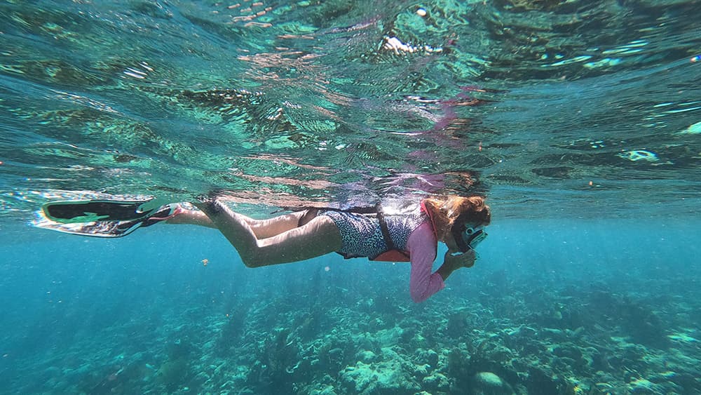 a child snorkeling in beautiful clear water