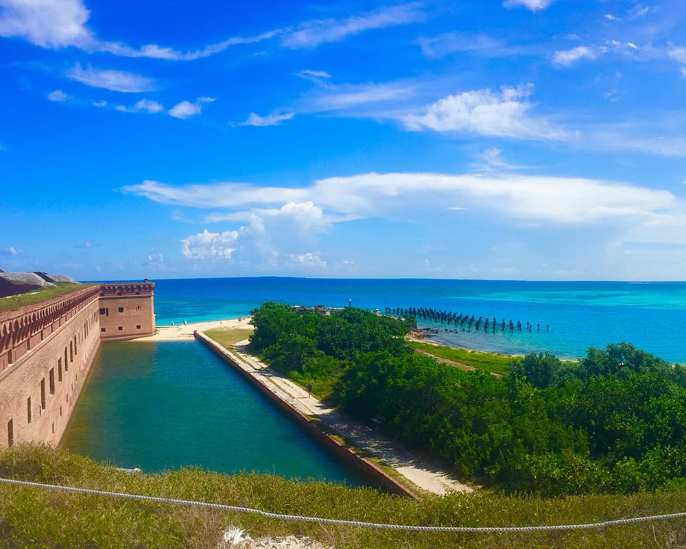 the brick and stone walls of fort jefferson meet the turqoise waters of the ocean in Dry Tortugas National Park