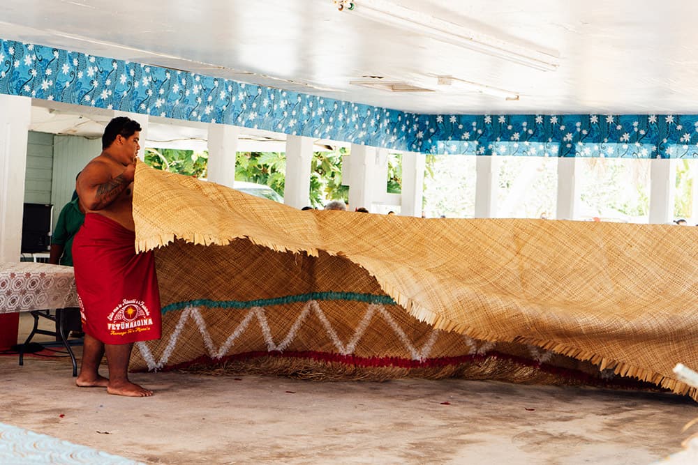 a person folding a large woven object