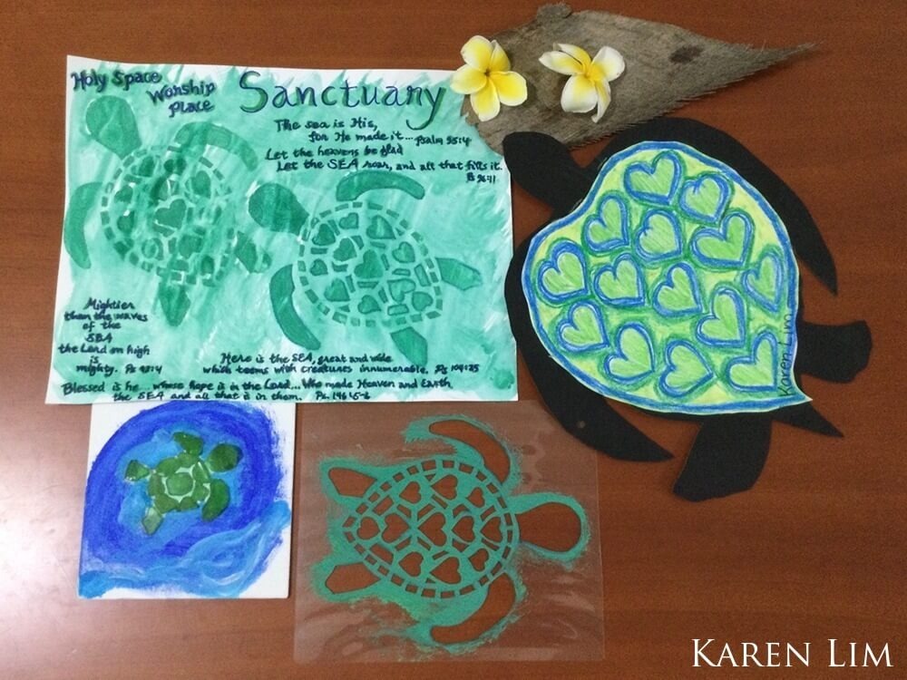 Watercolor with two stenciled images of green sea turtles; surrounded by the freehand written SANCTUARY and Scriptures with the words 'Sea' in them; coconut husk and two Pu'a blossoms 
                                    representing American Samoa; multimedia art of acrylic paint blue and white wave
                                    background with a mosaic green sea turtle upcycled from broken sea glass removed
                                    from the sand during oceanside clean-up; paper and crayon sea turtle showing hearts
                                    representing love of nature and sanctuary.