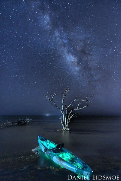 Kayak on shore with Milky Way.