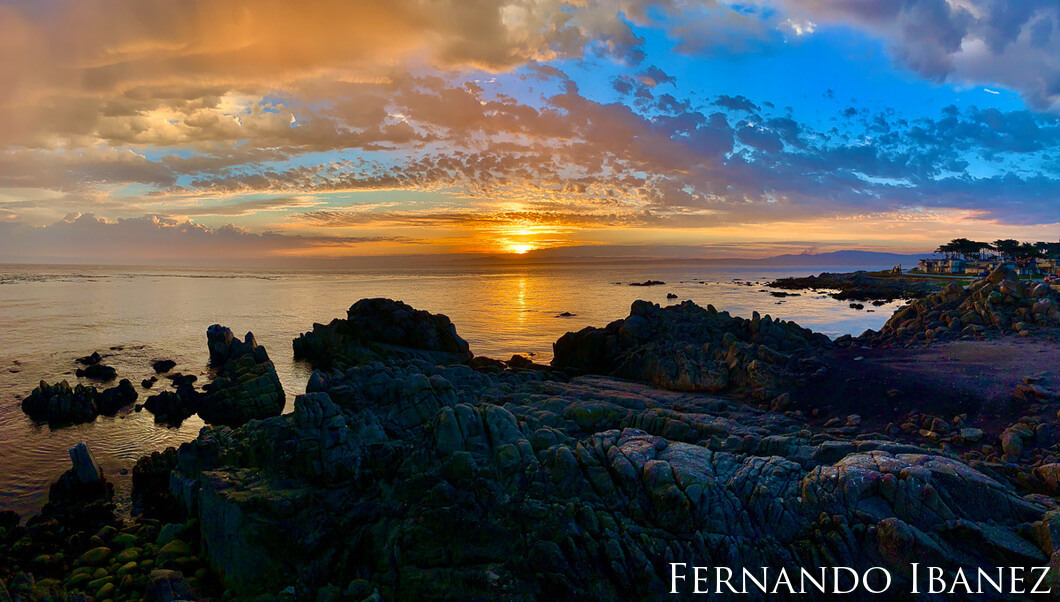 Sunset over a rocky coastline in Monterey.