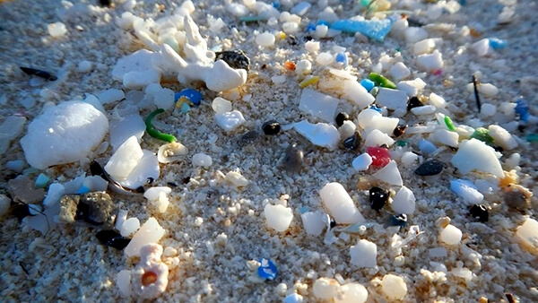 Microplastics in sand on beach.