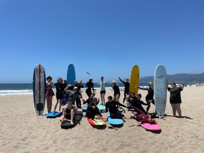 A group of surfers pose for a photo at a camp hosted by Queer Surf.