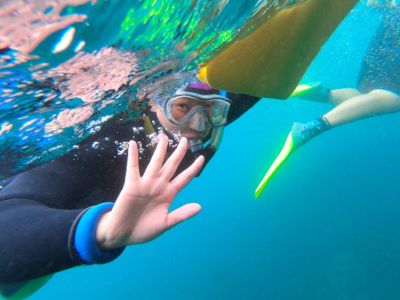 A Queer Surf member peers beneath the waves while snorkeling near Catalina Island.