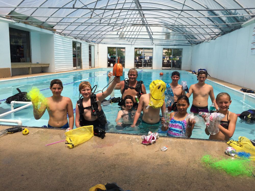 Young divers engage in ocean conservation and stewardship activities while practicing their dive skills.