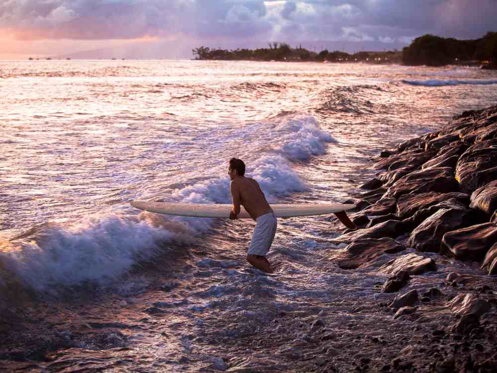 surfer entering the waves