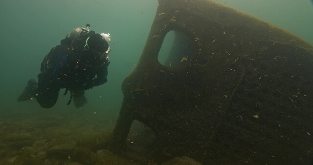 Diver swimming near shipwreck