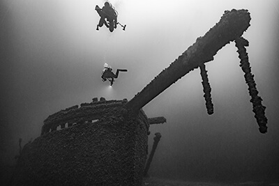 divers swim above the St. Peter ship wreck