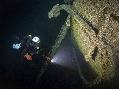A diver inspects the bow of Queen of the Lakes